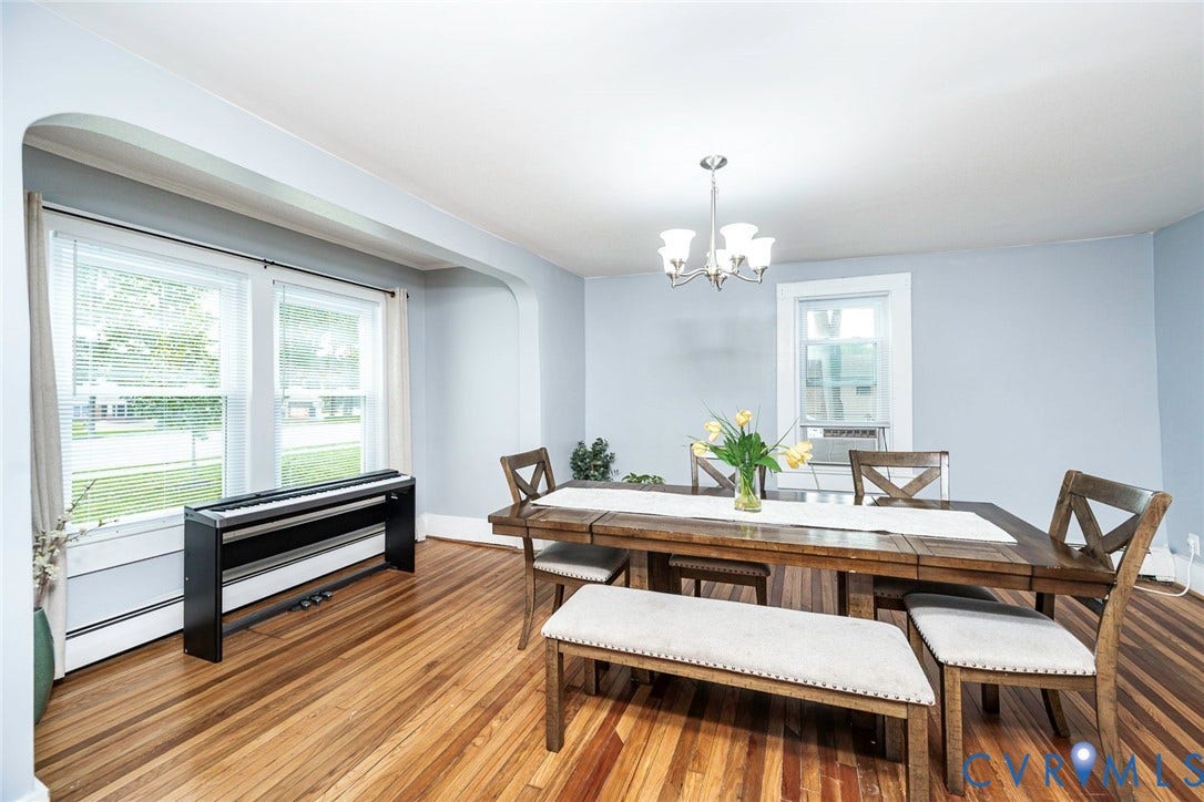 1818 Arlington Road, Hopewell, VA 23860 Dining area featuring natural wood-finish flooring, an arched cased opening, and a multi-arm chandelier
