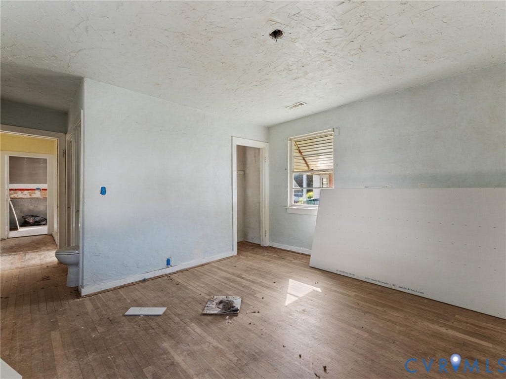 2900 Overton Road, Henrico, VA 23228 Interior space featuring wood-finish flooring, a single-hung window with metal awning, and neutral wall surfaces