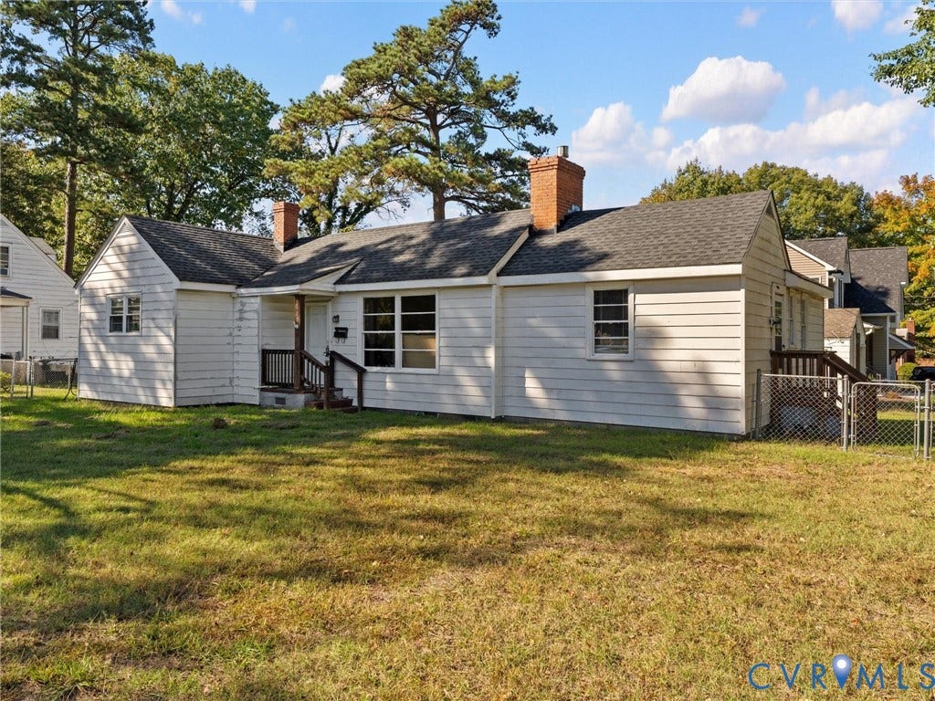 2900 Overton Road, Henrico, VA 23228 Single-story exterior featuring white horizontal siding, two brick chimneys, a shingled roof, and a fenced perimeter