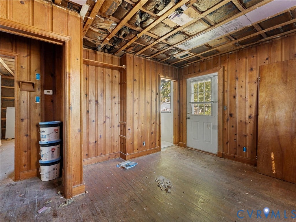2900 Overton Road, Henrico, VA 23228 Interior space featuring natural wood paneling, exposed ceiling joists, hardwood flooring, and a glass-paneled exterior door