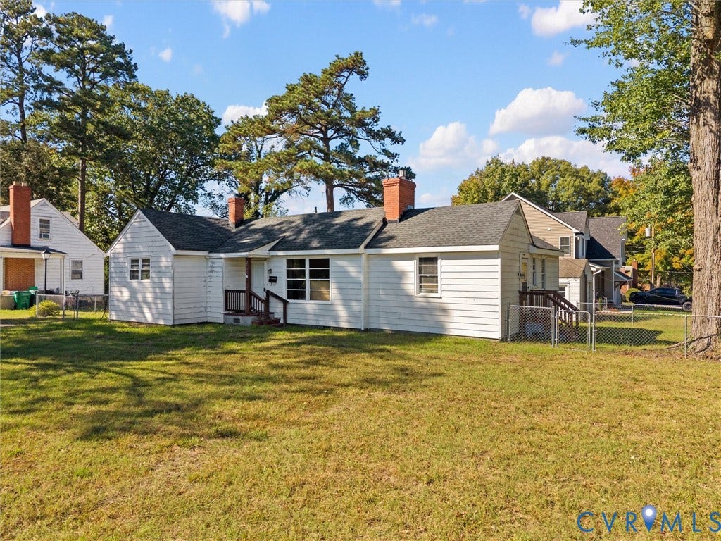 2900 Overton Road, Henrico, VA 23228 Single-story residence featuring a white lap siding exterior, asphalt shingle roof, two brick chimneys, and an expansive lawn