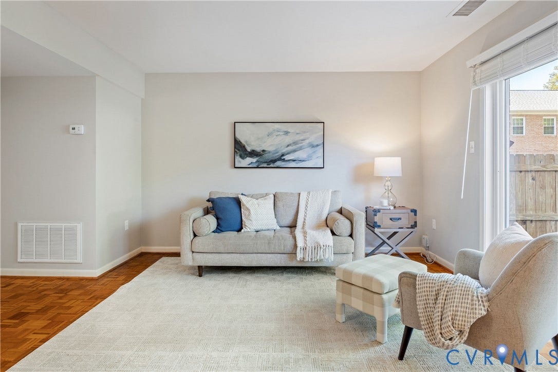 9131 Derbyshire Road, #B, Deerwood Condominiums, Henrico, VA 23229 Parquet wood-finish flooring, neutral wall tones, and sliding glass door with integrated blinds