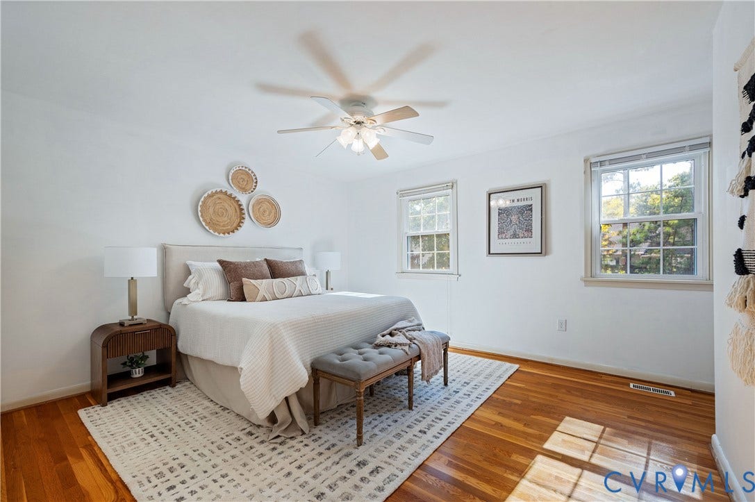 9131 Derbyshire Road, #B, Deerwood Condominiums, Henrico, VA 23229 Bedroom featuring wood-finish flooring, dual windows with natural light, and a ceiling-mounted light fixture with a fan