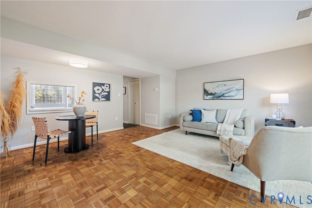9131 Derbyshire Road, #B, Deerwood Condominiums, Henrico, VA 23229 Parquet wood-finish flooring, neutral wall paint, recessed ceiling light, and horizontal window