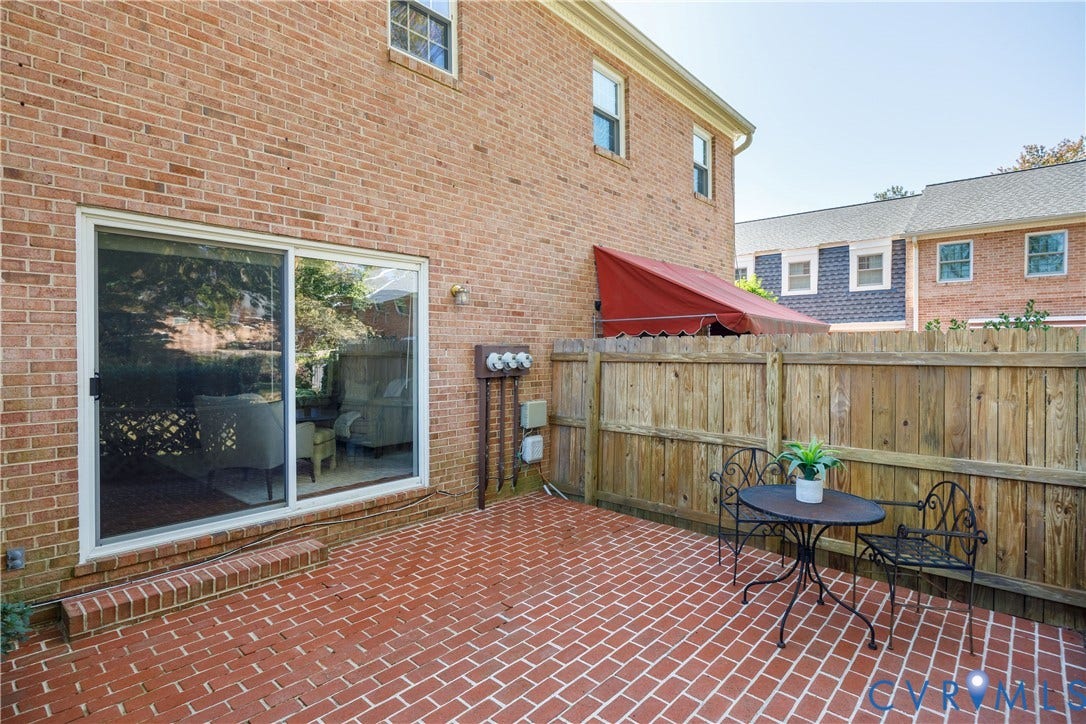 9131 Derbyshire Road, #B, Deerwood Condominiums, Henrico, VA 23229 Brick patio with a sliding glass door and a wood privacy fence