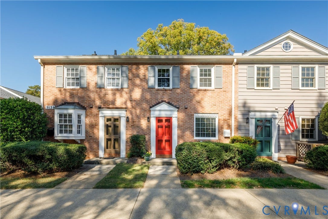 9131 Derbyshire Road, #B, Deerwood Condominiums, Henrico, VA 23229 Multi-story exterior featuring a brick facade with horizontal siding, paneled front doors, multi-light windows, and a pedimented entryway