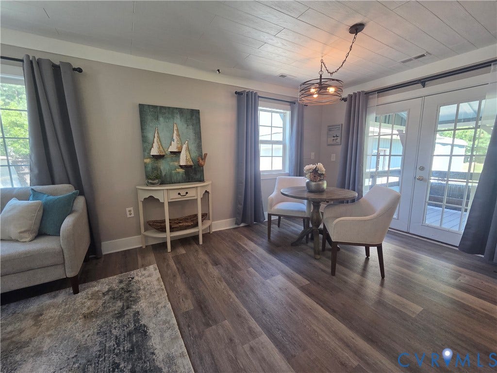 7620 Cypress Drive, Lanexa, VA 23089 Wood-finish flooring, plank-style ceiling, multi-light industrial pendant fixture, and double French doors with grid glass panels