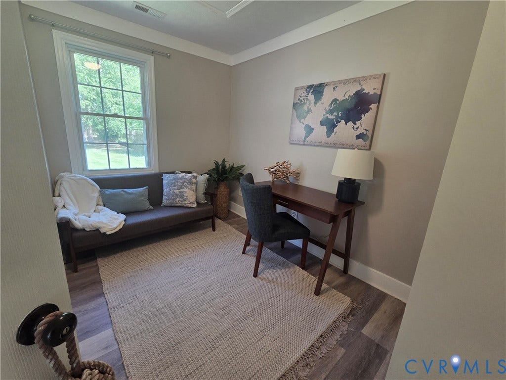 7620 Cypress Drive, Lanexa, VA 23089 Neutral interior featuring wood-finish flooring, crown molding, and a multi-pane window with white casing