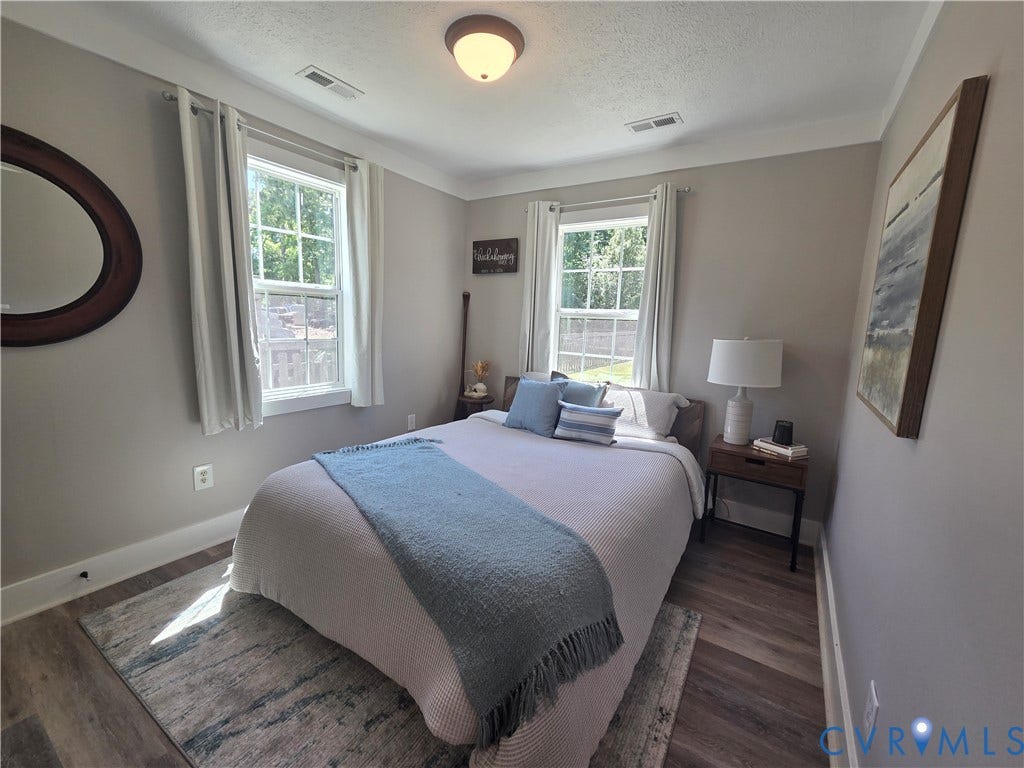 7620 Cypress Drive, Lanexa, VA 23089 Wood-finish flooring, neutral wall tones, two multi-pane windows, and a central dome-style ceiling light fixture