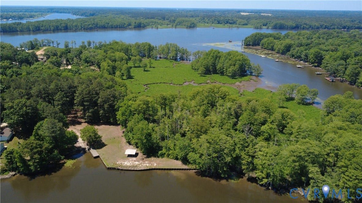 7620 Cypress Drive, Lanexa, VA 23089 Waterfront acreage featuring mature timber, a shoreline bulkhead, a private dock, and an open-sided pavilion