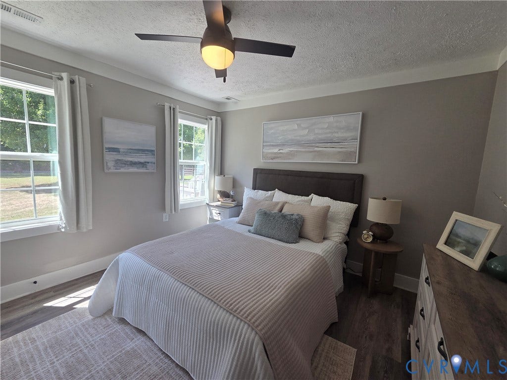 7620 Cypress Drive, Lanexa, VA 23089 Neutral-toned interior featuring wood-finish flooring, multi-pane windows, and a ceiling fan with integrated lighting
