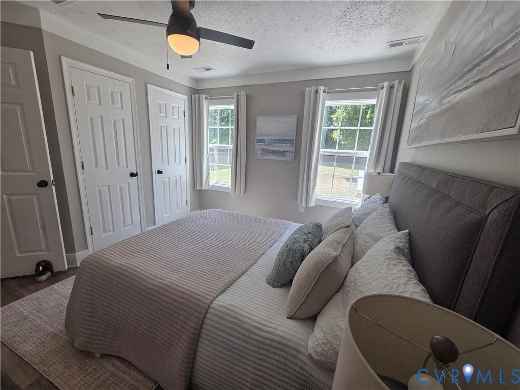 7620 Cypress Drive, Lanexa, VA 23089 Interior space featuring dual windows with grid detailing, multi-panel interior doors, and a ceiling fan with integrated lighting