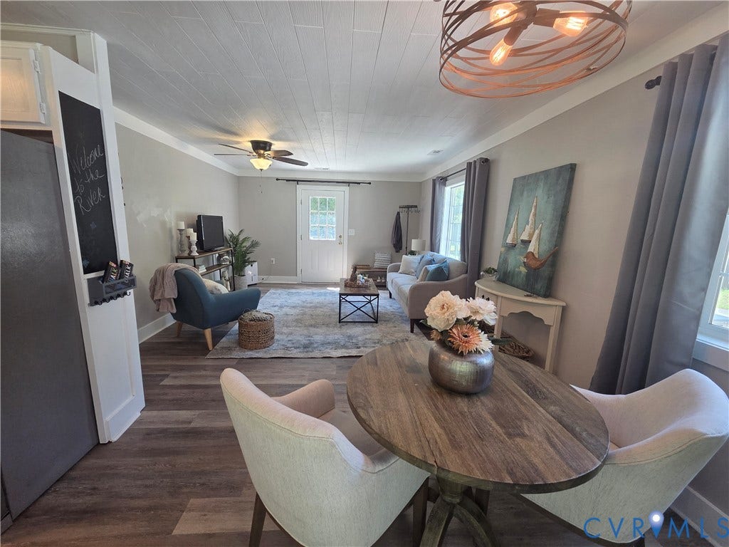 7620 Cypress Drive, Lanexa, VA 23089 Plank-style wood-finish flooring, white shiplap ceiling, circular bronze-tone cage pendant lighting, and a built-in chalkboard panel