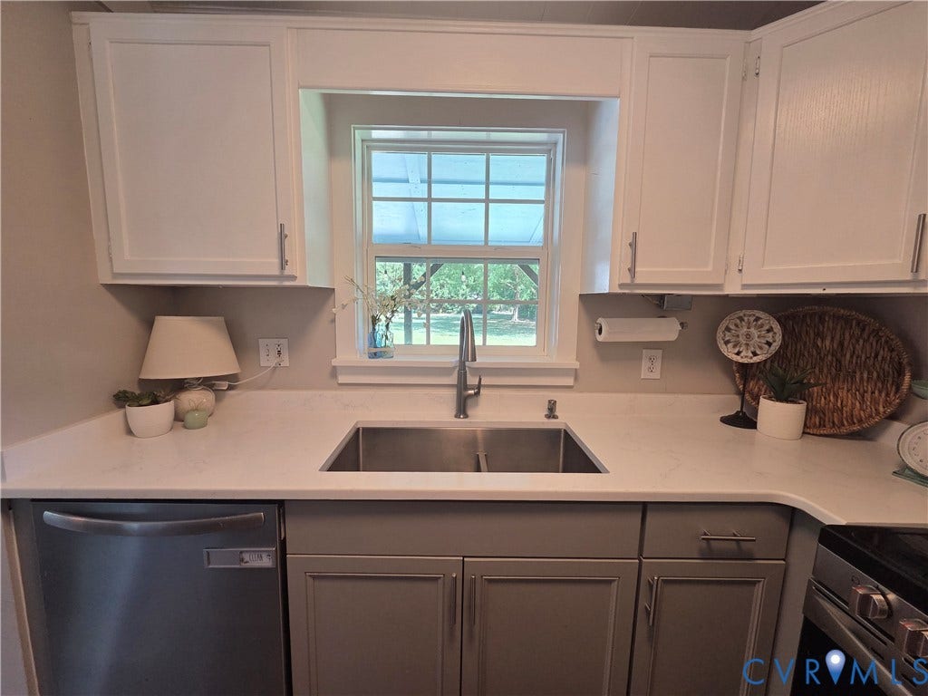 7620 Cypress Drive, Lanexa, VA 23089 Kitchen featuring shaker-style cabinetry, white solid-surface countertops, dual-basin stainless steel sink, gooseneck faucet, and stainless steel dishwasher