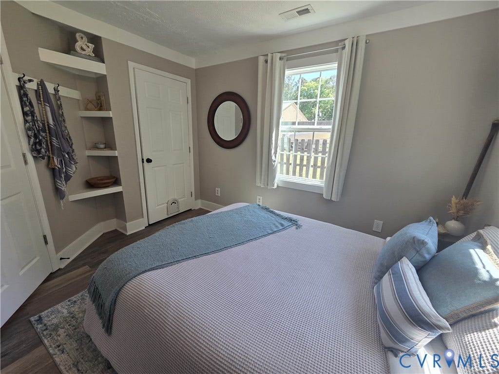 7620 Cypress Drive, Lanexa, VA 23089 Built-in corner shelving, wood-finish flooring, and a single-pane window with a multi-light sash design