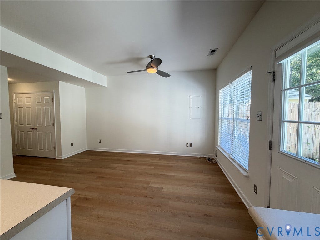 3105 Friars Walk Lane, Glen Allen, VA 23059 Interior space featuring wood-finish flooring, a ceiling fan with integrated lighting, dual-pane windows with horizontal blinds, and a paneled door with glass inlay