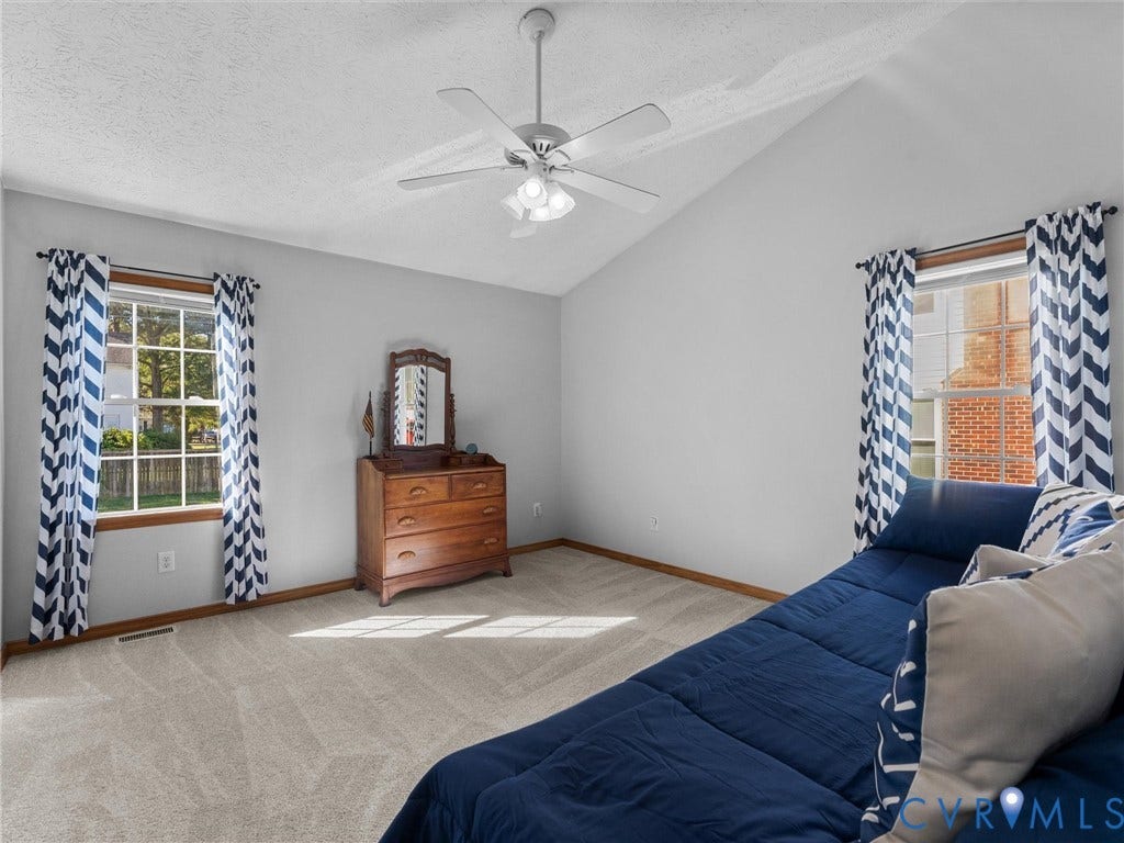 209 Taraby Drive, Hunters Run, Sandston, VA 23150 Vaulted ceilings, carpeted flooring, and dual windows with grid muntins, complemented by a central ceiling fan with integrated lighting
