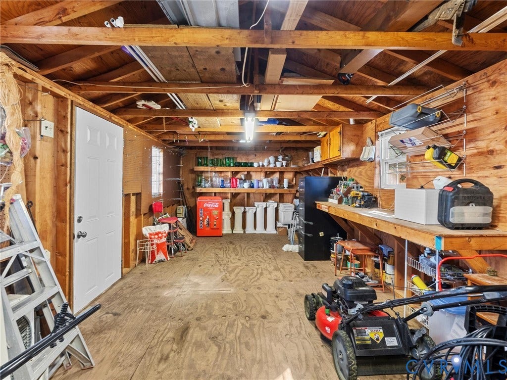 209 Taraby Drive, Hunters Run, Sandston, VA 23150 Outbuilding featuring exposed wooden rafters, plywood wall sheathing, durable plywood flooring, a solid-core entry door, and integrated built-in wooden shelving