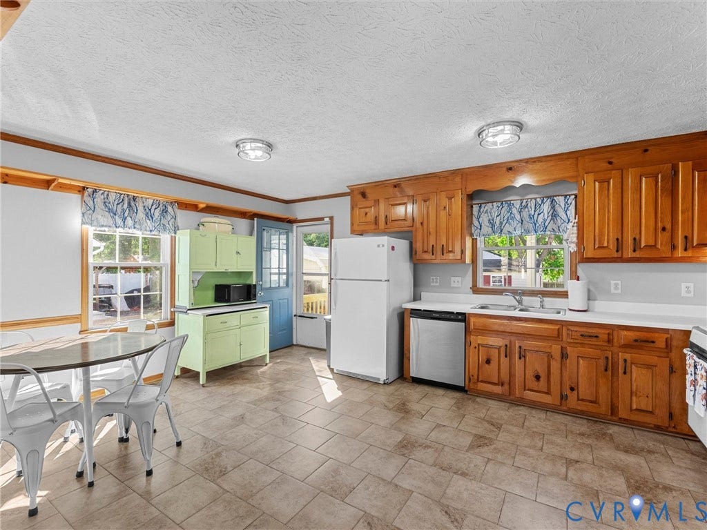 209 Taraby Drive, Hunters Run, Sandston, VA 23150 Kitchen featuring natural wood cabinetry, tile flooring, built-in lower cabinetry with an integrated hutch, stainless steel dishwasher, and dual-basin sink with a gooseneck faucet