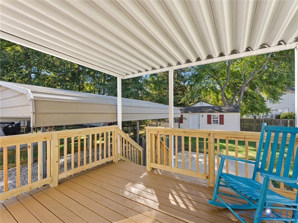 209 Taraby Drive, Hunters Run, Sandston, VA 23150 Covered deck featuring wood-finish decking, natural wood railings, and a corrugated metal overhead structure