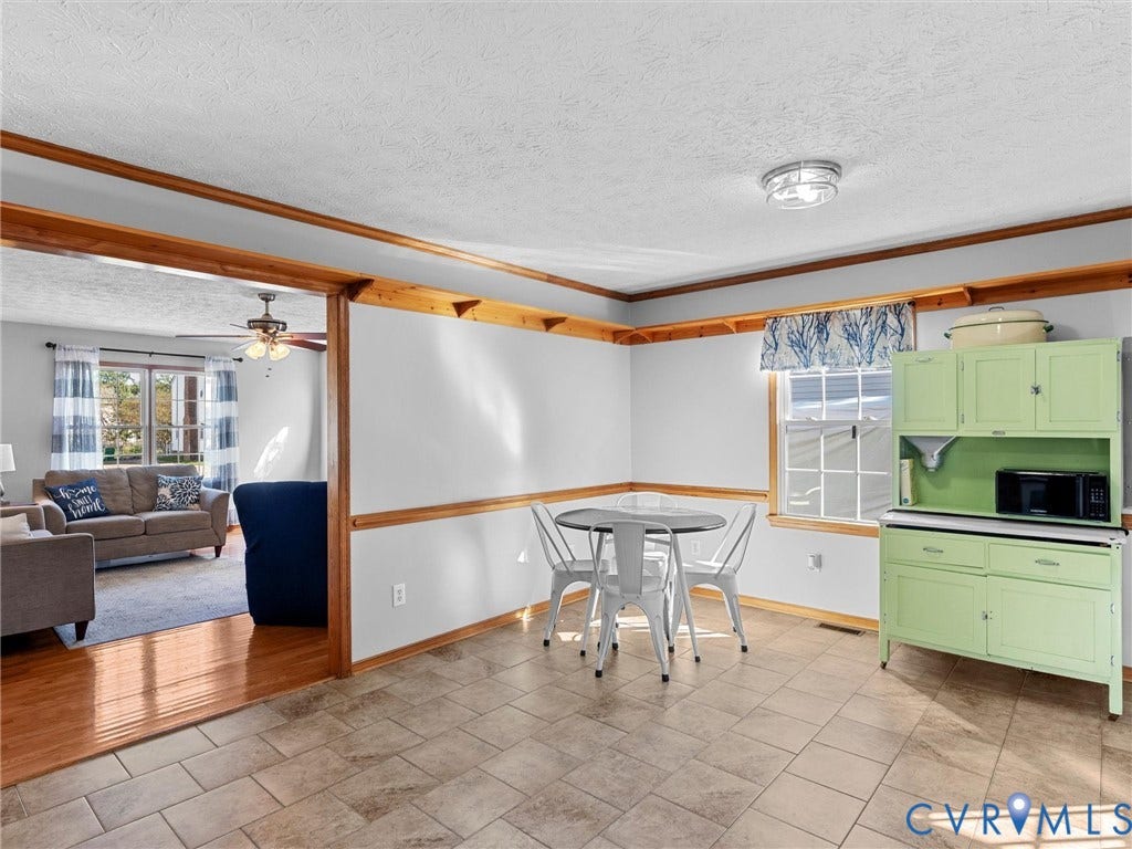 209 Taraby Drive, Hunters Run, Sandston, VA 23150 Neutral-toned tile flooring, natural wood-finish crown molding, chair rail detailing, and grid-style windows