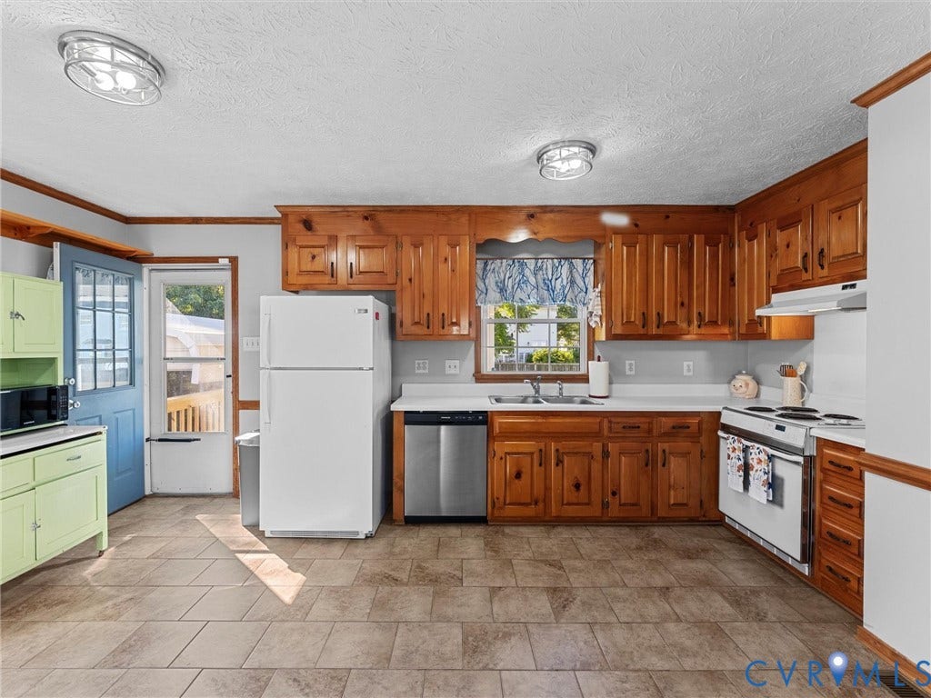 209 Taraby Drive, Hunters Run, Sandston, VA 23150 Kitchen featuring natural wood cabinetry, tile flooring, stainless steel dishwasher, and white appliances