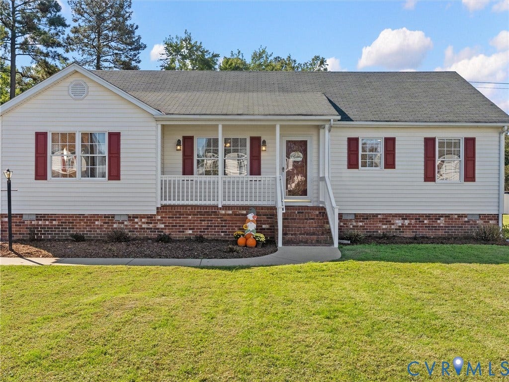 209 Taraby Drive, Hunters Run, Sandston, VA 23150 Single-story exterior featuring light-toned vinyl siding, brick foundation, a covered front porch with white railing, and dark red window shutters