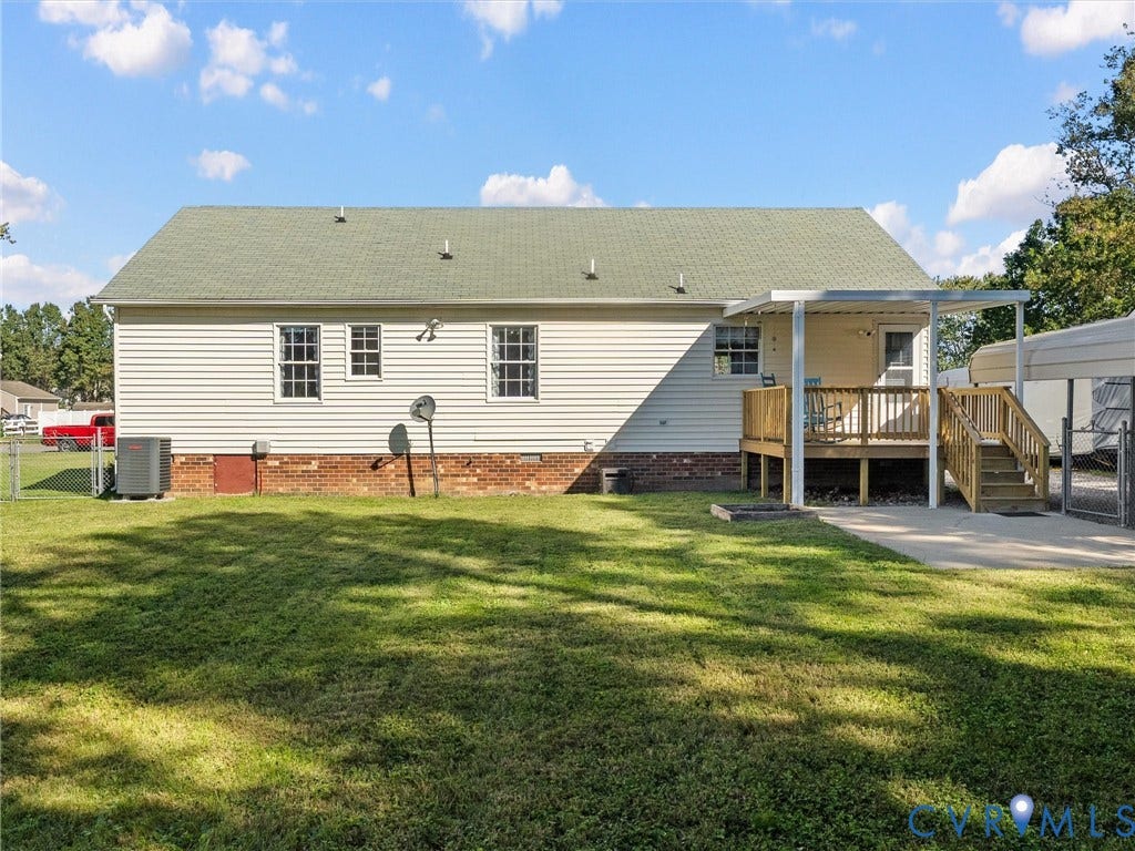209 Taraby Drive, Hunters Run, Sandston, VA 23150 Rear exterior featuring vinyl siding, brick foundation, elevated wood deck with cover, and metal carport