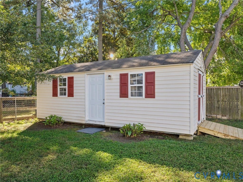 209 Taraby Drive, Hunters Run, Sandston, VA 23150 Outbuilding featuring horizontal lap siding, red shutters, a shingled roof, and an exterior wooden access ramp