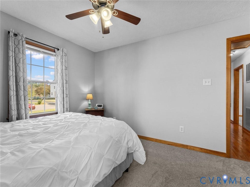 209 Taraby Drive, Hunters Run, Sandston, VA 23150 Neutral wall tones, ceiling fan with integrated lighting, window with wooden casing, and wall-to-wall carpeting