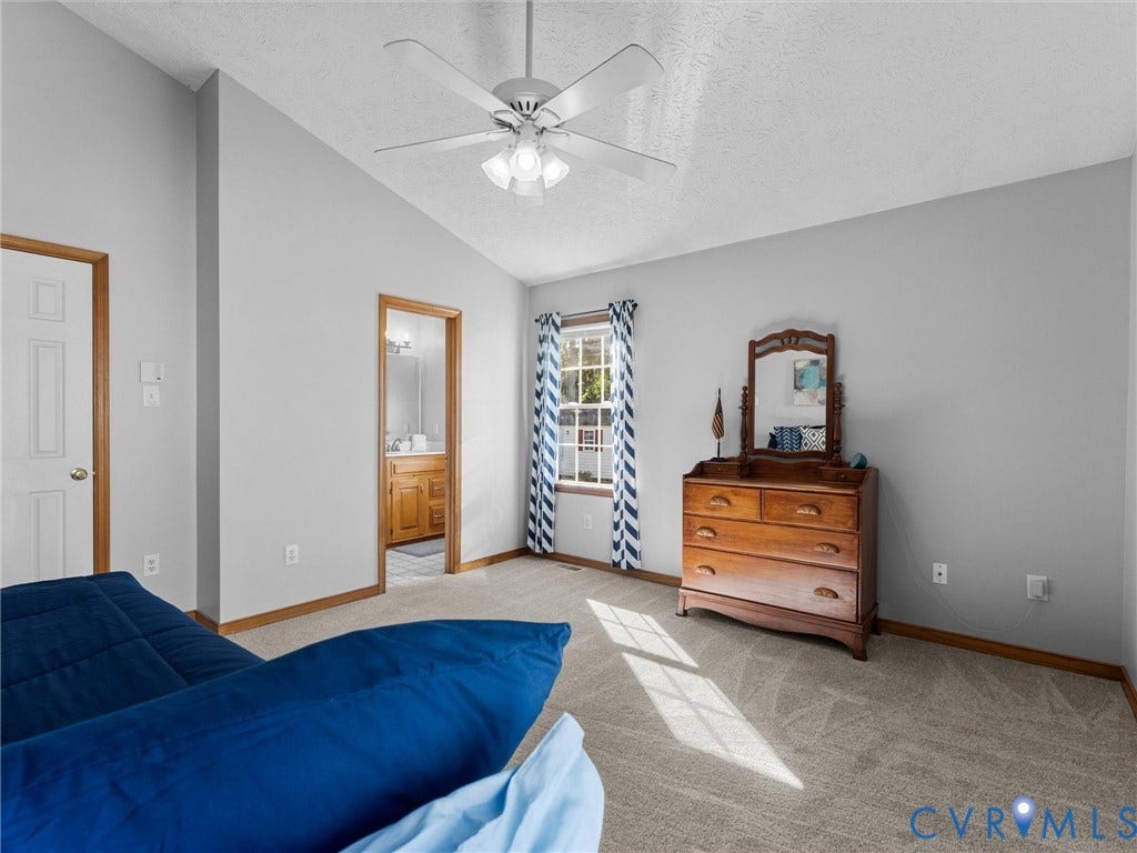 209 Taraby Drive, Hunters Run, Sandston, VA 23150 Vaulted ceiling featuring a central multi-blade ceiling fan with integrated light fixture, neutral wall finishes, and wall-to-wall carpeting