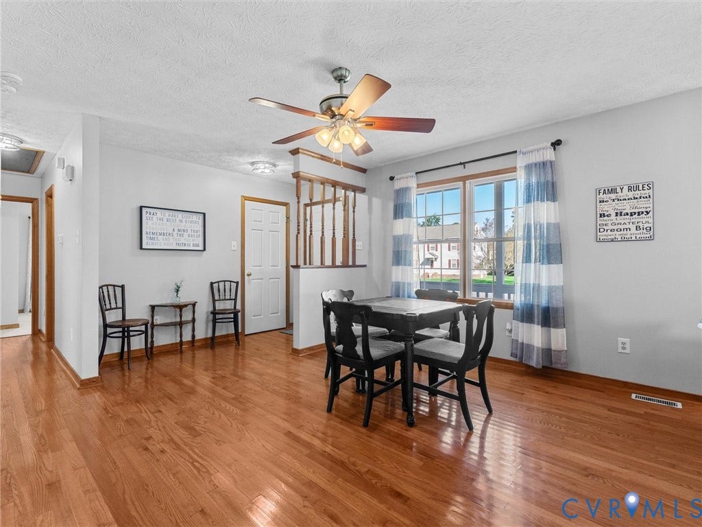 209 Taraby Drive, Hunters Run, Sandston, VA 23150 Wood-finish flooring, half-wall with wooden baluster detail, and a multi-light ceiling fan