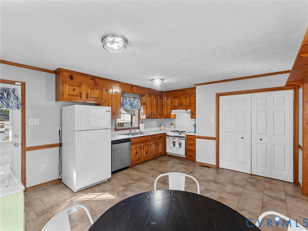 209 Taraby Drive, Hunters Run, Sandston, VA 23150 Kitchen featuring natural wood cabinetry, white appliances, tile flooring, and dual-door closet storage