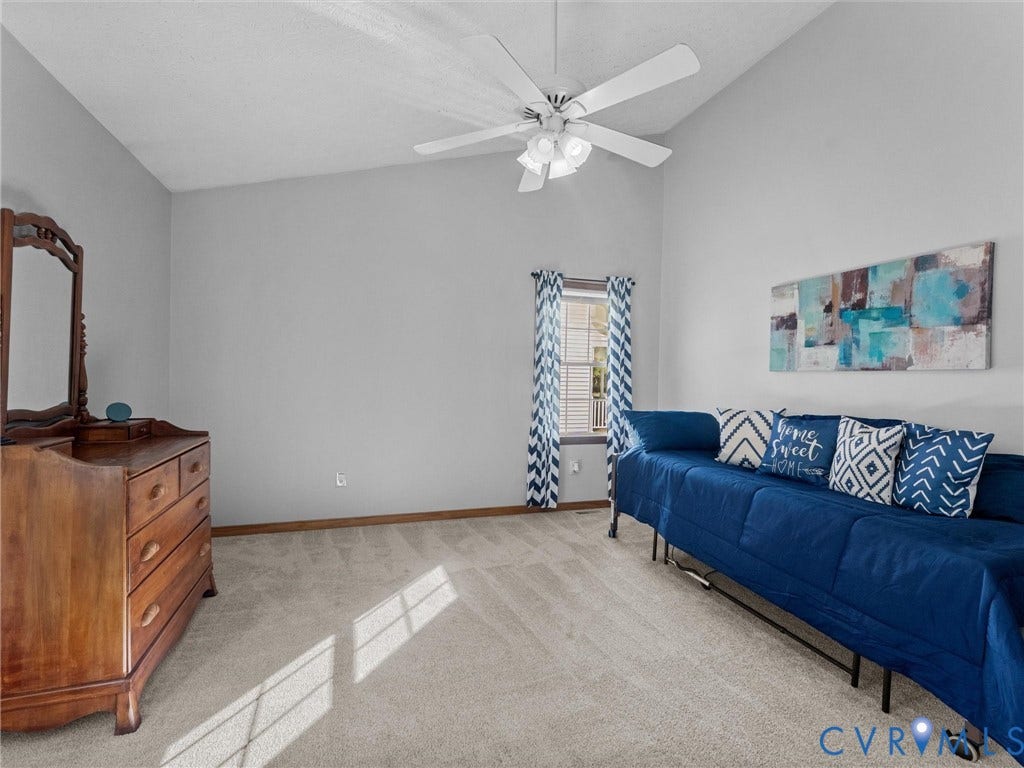 209 Taraby Drive, Hunters Run, Sandston, VA 23150 Vaulted ceiling featuring a white multi-blade ceiling fan with integrated light fixture and neutral-toned wall-to-wall carpeting