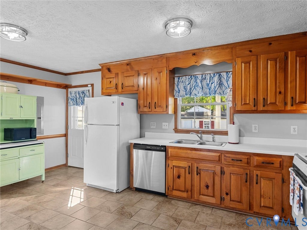 209 Taraby Drive, Hunters Run, Sandston, VA 23150 Kitchen featuring wood cabinetry, stainless steel dishwasher, tile flooring, dual-basin sink, and contrasting pastel green built-in hutch