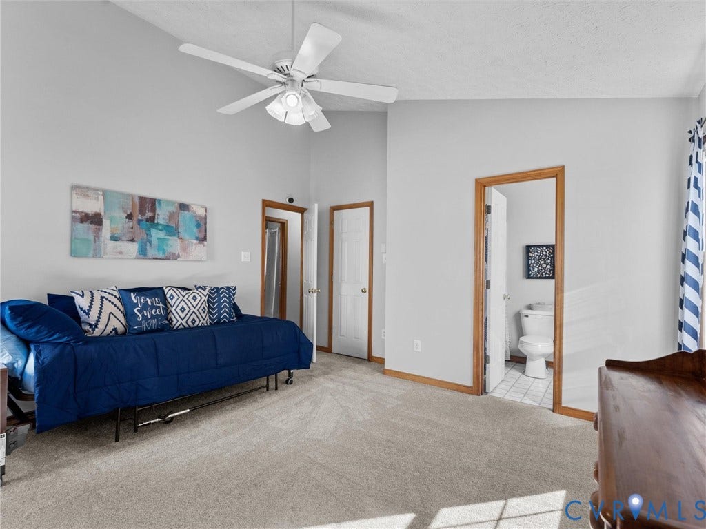 209 Taraby Drive, Hunters Run, Sandston, VA 23150 Vaulted ceiling with central light fixture and ceiling fan, neutral carpeting, and wood-trim door frames