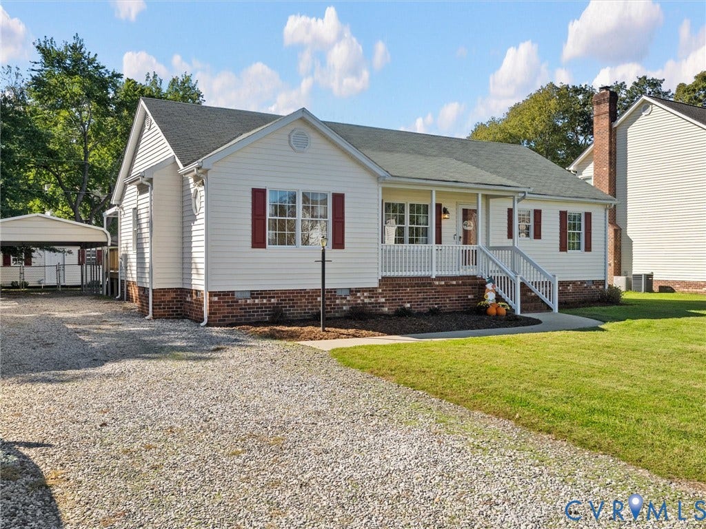 209 Taraby Drive, Hunters Run, Sandston, VA 23150 Single-story exterior featuring a brick foundation, horizontal siding, shutter accents, a front porch with white railing, and a detached carport