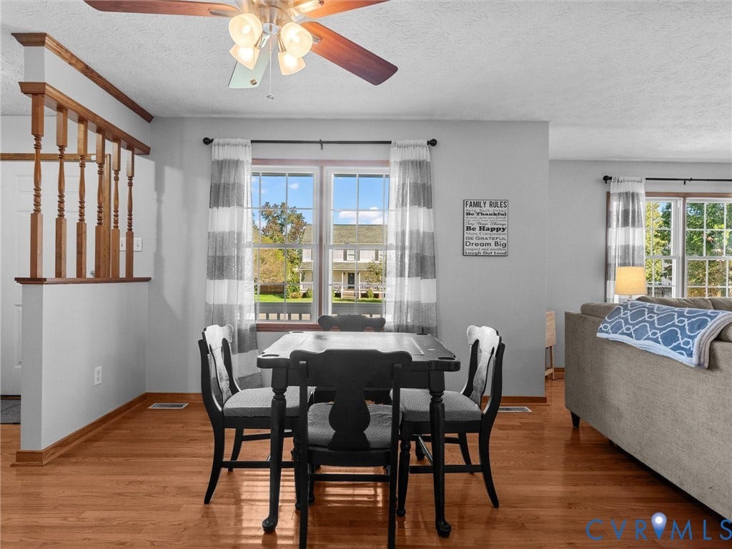 209 Taraby Drive, Hunters Run, Sandston, VA 23150 Wood-finish flooring, natural light through multi-pane windows, and wood-railing staircase accent