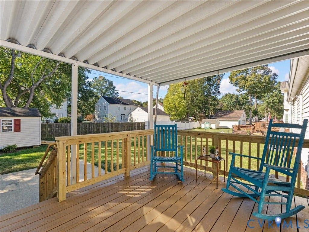 209 Taraby Drive, Hunters Run, Sandston, VA 23150 Elevated deck featuring wood-finish decking, a wooden railing, and a corrugated metal patio cover
