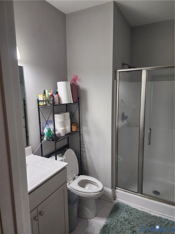 1502 N 19th Street, Church Hill, Richmond, VA 23223 Bathroom featuring a single-sink vanity with a solid-surface countertop, a glass-enclosed shower, and tile flooring