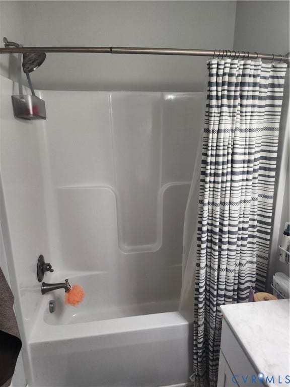 1502 N 19th Street, Church Hill, Richmond, VA 23223 Acrylic tub-and-shower surround with a brushed metal showerhead, matching faucet hardware, and a curved adjustable shower rod