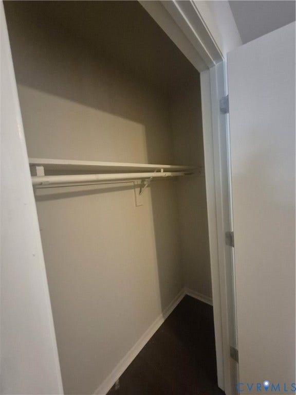 17 Jarratt Court, Petersburg, VA 23803 Reach-in closet featuring wood-finish flooring, neutral wall paint, and an integrated upper shelving and rod system