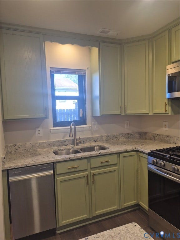 17 Jarratt Court, Petersburg, VA 23803 Kitchen featuring sage green shaker cabinetry, light-toned stone-finish countertops, stainless steel appliances, and a double-basin undermount sink with a high-arc pull-down faucet