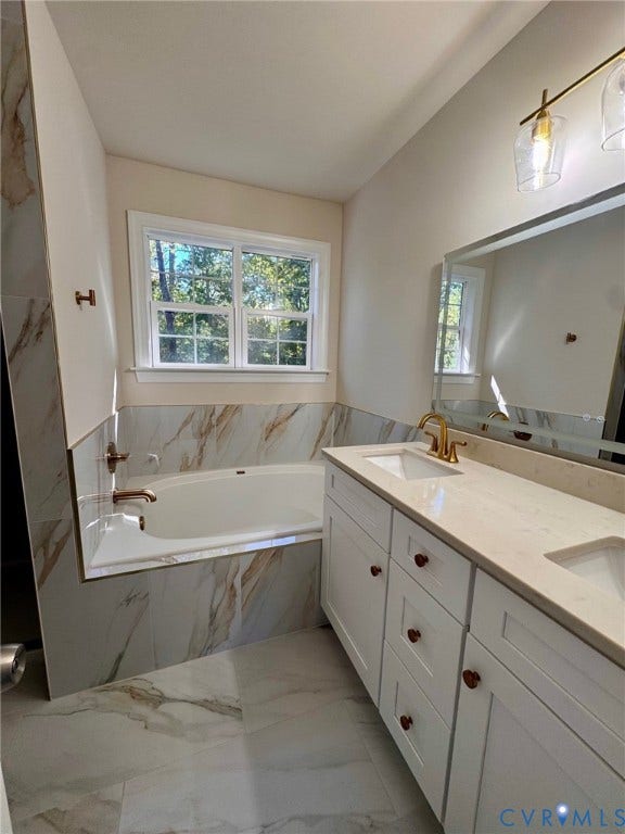 10984 Elmont Woods Drive, Elmont, Glen Allen, VA 23059 Double vanity with white cabinetry, quartz countertop, dual integrated sinks, and brass-tone hardware