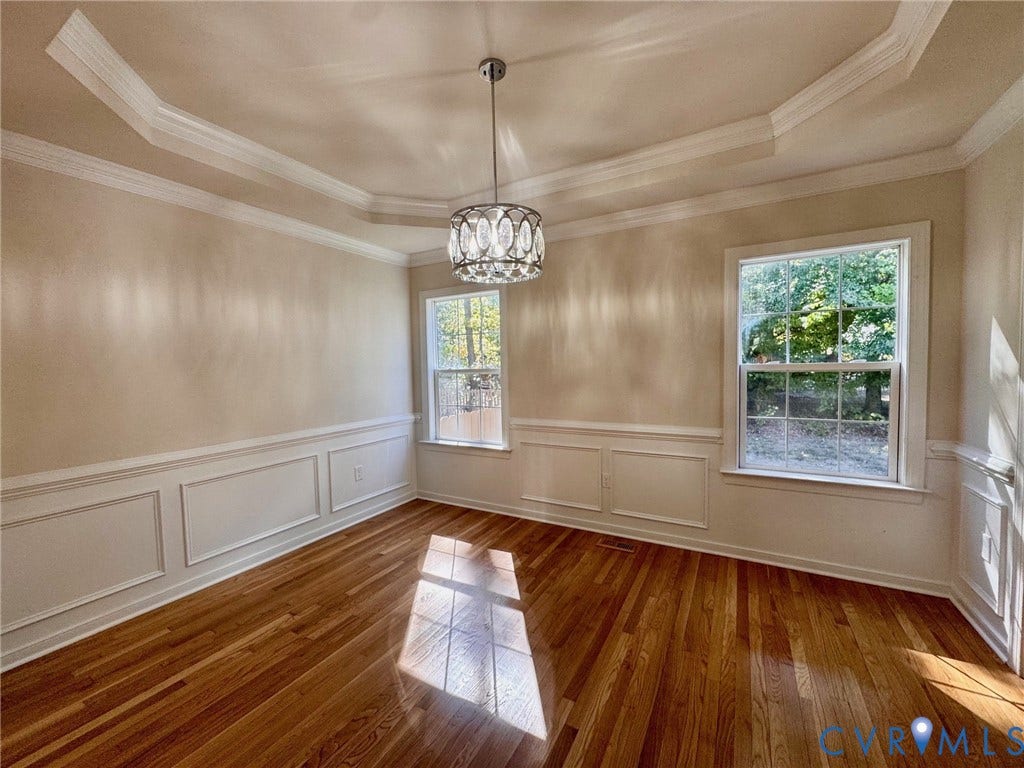 10984 Elmont Woods Drive, Elmont, Glen Allen, VA 23059 Tray ceiling with crown molding, wainscoting, wood-finish flooring, and a decorative pendant light fixture