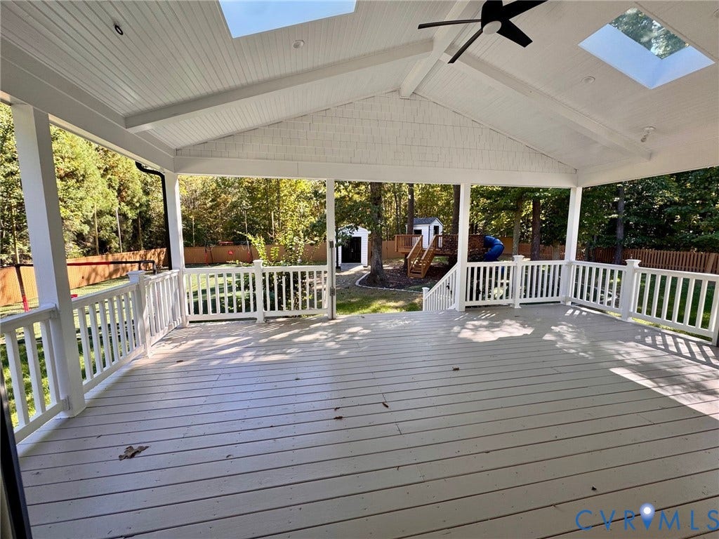 10984 Elmont Woods Drive, Elmont, Glen Allen, VA 23059 Covered deck featuring a vaulted tongue-and-groove ceiling, dual skylights, a ceiling fan, and white railing enclosures