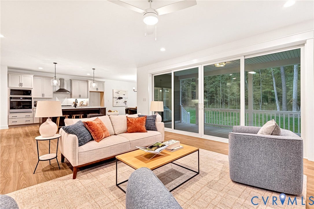 9107 Terroir Lane, Viniterra Villas, New Kent, VA 23124 Open-concept living space featuring wood-finish flooring, recessed lighting, and a modern ceiling fan