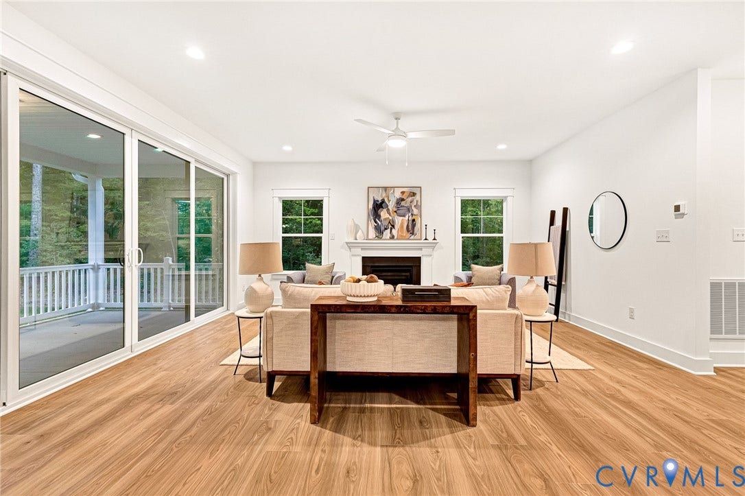 9107 Terroir Lane, Viniterra Villas, New Kent, VA 23124 Living space featuring wood-finish flooring, a fireplace with a mantel, recessed lighting, a ceiling fan, and large sliding glass doors