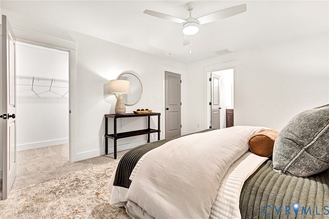 9107 Terroir Lane, Viniterra Villas, New Kent, VA 23124 Neutral-toned carpeting, white walls, integrated ceiling fan with light kit, and interior doors with matte black hardware