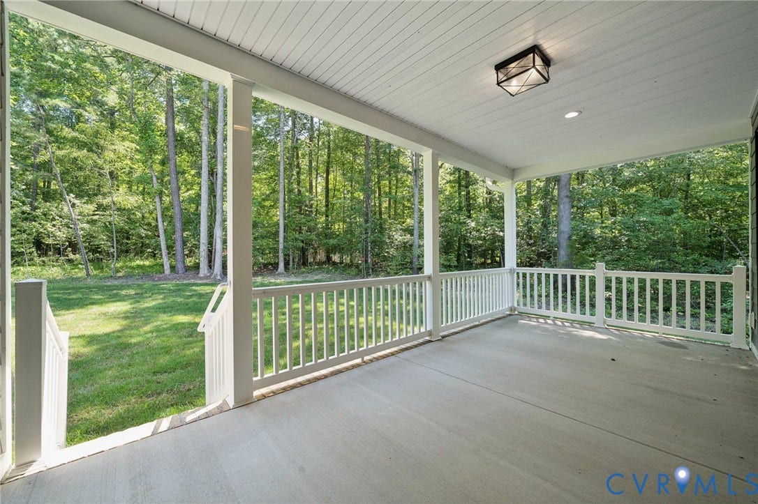 9107 Terroir Lane, Viniterra Villas, New Kent, VA 23124 Covered porch featuring concrete flooring, white beadboard ceiling, flush-mount lighting, and white railings